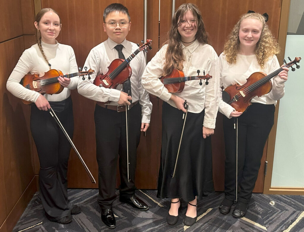 The middle school strings students are pictured from left: Kailey McIlvain (MMS), Leo Nguyen (MMS), Ruby Hunter (SMS) and Abby Allman (SMS).